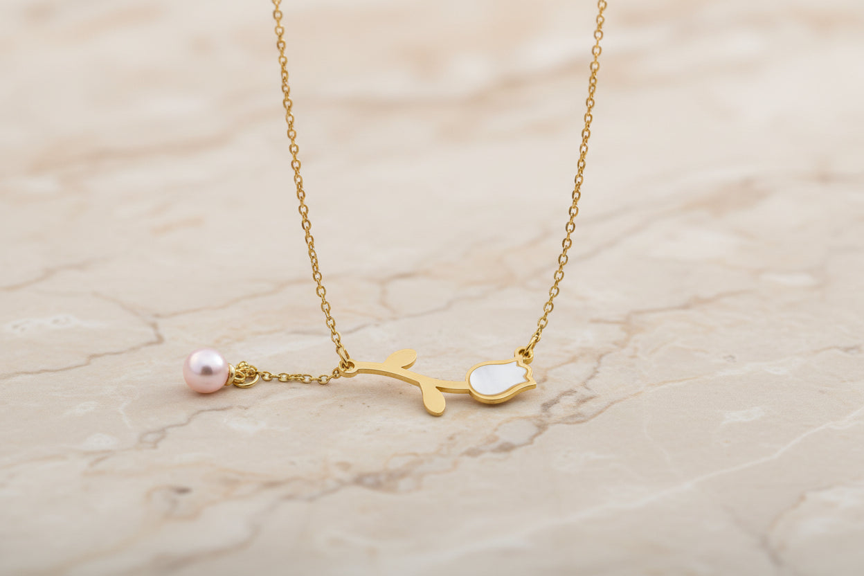 Gold necklace with a branch and pearl pendant