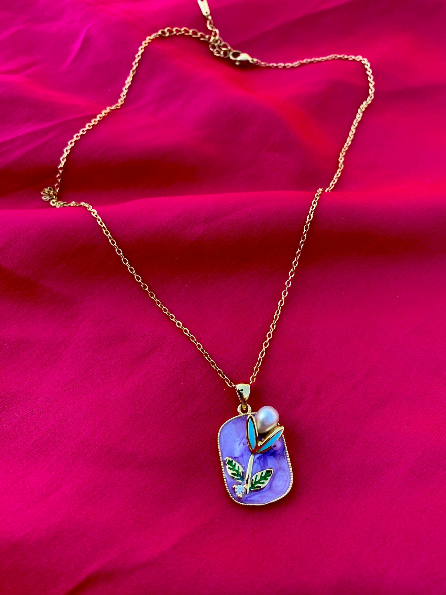 Modern Necklace with Pearl and Leaf Details on a Purple Background