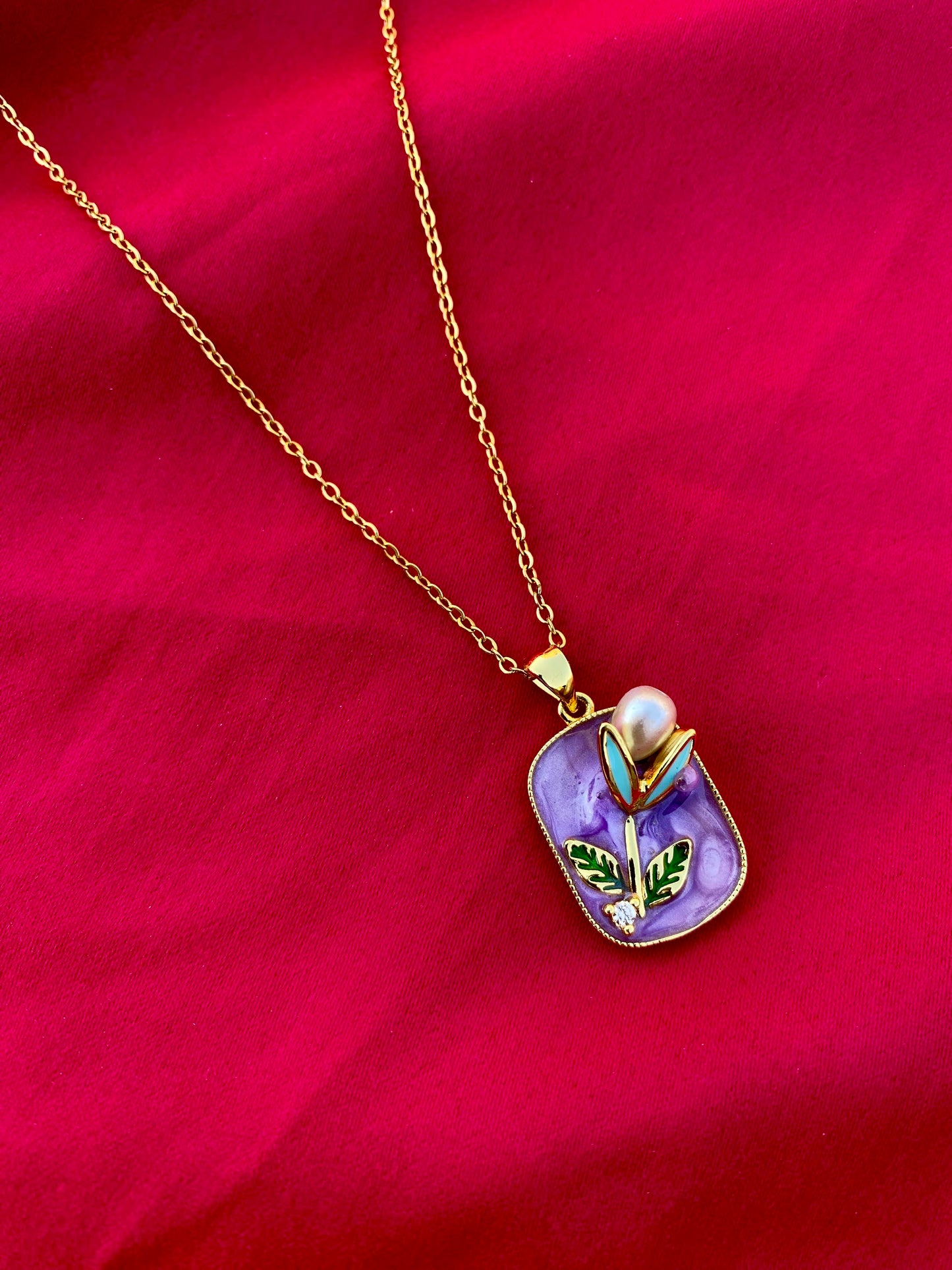 Modern Necklace with Pearl and Leaf Details on a Purple Background