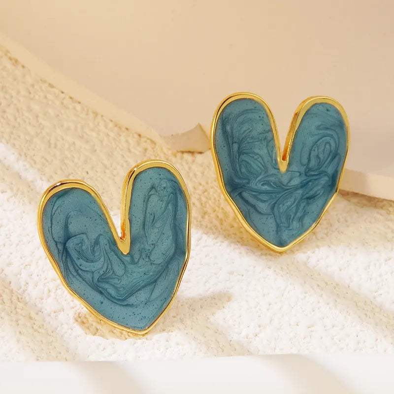 Teal swirl enamel heart stud earrings with gold border