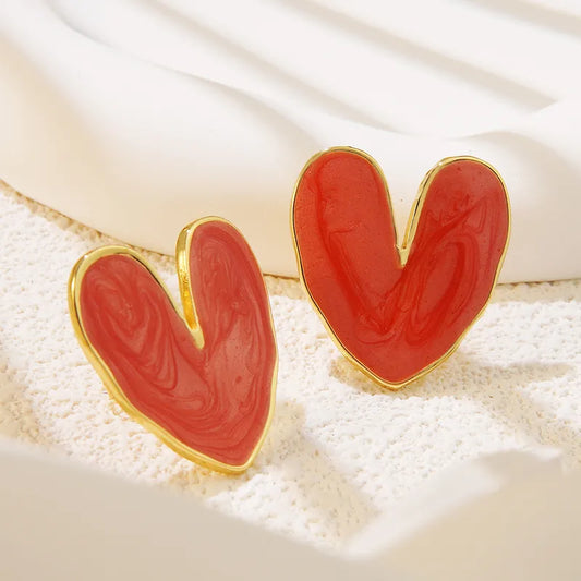 Coral red enamel heart stud earrings with gold border