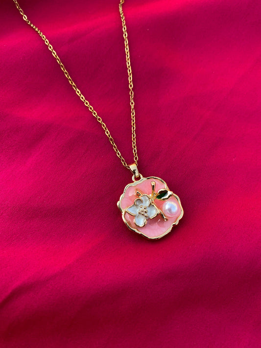 Necklace with a floral pendant on a red fabric background